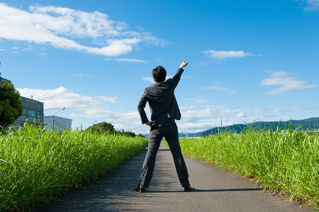 空を指さすスタッフ